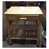 Kitchen cart on wheels with pull-out cutting board