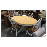 Kitchen table with four chairs show use wear from
