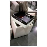 Upholstered ottoman, cream colored with reversible