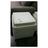 Upholstered ottoman, cream colored with reversible