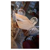 Kitchen table and four chairs. Table has 12"