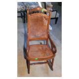 Caned rocker. Caning on back needs repaired or
