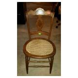 Single side chair. Carved back and cane seat.