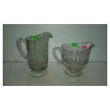 Two clear glass beverage pitchers