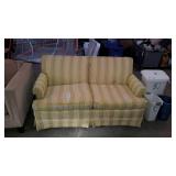 Yellow and green sofa, cushions have tears and