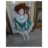 Red headed porcelain doll, 29 inches tall.