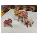 3 cloth covered elephants, one missing tusk.