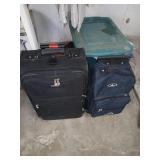 2 suitcases and a plastic bin
