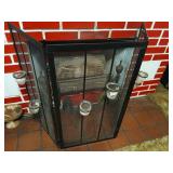 Fireplace screen with candle holders.