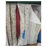 Vintage women's clothing in 4 hanging cases