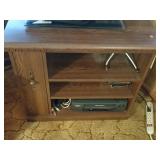 TV stand with VCR and tapes.