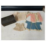 Vintage doll clothes in a mini trunk.