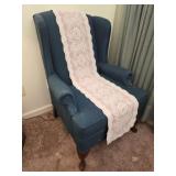 Green upholstered winged back chair