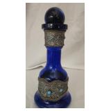 Blue glass decanter with metal accents