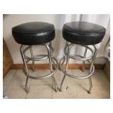 Pair of black cushion stools