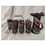 7 glass cups and pitcher with metal cup holder