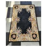 Black and tan decorative rug