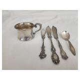 Sterling silver cup butter knives and a spoon