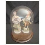 2 porcelain figurines in glass dome