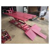 Red industrial hydrolic motorcycle lift