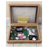 Showcase filled with misc costume jewelry and more