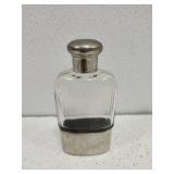 Antique glass pocket flask with metal sleeve