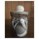 Plastic jar of sea shells