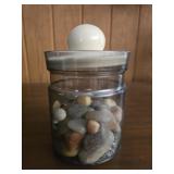 Plastic jar full of rocks