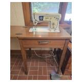 Vintage singer swing machine in cabinet