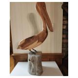Sold Cedar Pelican sitting on wood stump
