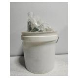 White small bucket full of fish supplies