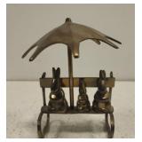Metal rabbits on bench decorative piece