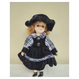 Vintage antique porcelain doll in plaid dress