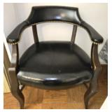 Vintage black leather chair with brass button trim