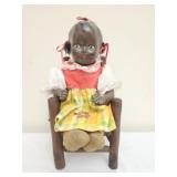 Vintage folk art style doll in wooden chair