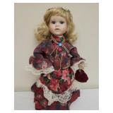 Vintage Christmas-themed porcelain doll