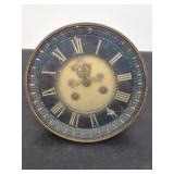 Heavy antique clock face has a broken spot