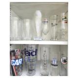 Shelf lot of beer glasses and more