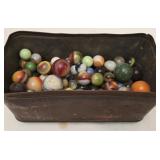 Tin container full of antique marbles