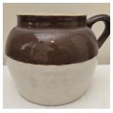 Brown and white pottery crock