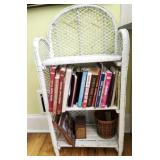White wicker shelf filled with cook books & more