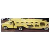 Vintage yellow metal Tonka truck with trailer