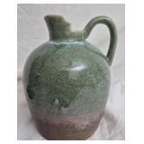 Green and brown glazed pottery jug