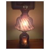 Purple lamp glass with a swirl or optic pattern