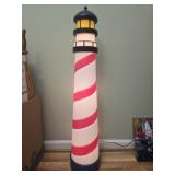 Red and white lighthouse light up yard decor