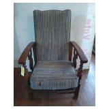 Old wooden reclining chair, has some rat holes