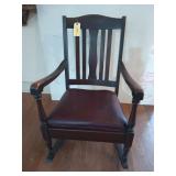 Old wooden rocker with upholstered seat