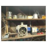 Contents of section of wall shelving: brass