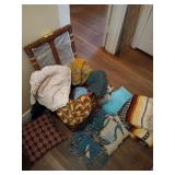 Cute laundry hamper full of blankets, crocheted