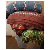 Plastic tub overflowing with blankets, many are